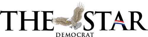 Eagle flying between black text "THE STAR DEMOCRAT," with red, white, blue stripe.